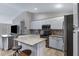 Charming kitchen with stainless steel appliances, a center island, granite counters, and an open layout design at 4091 S Dew Drop Ct, Gilbert, AZ 85297