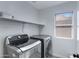 Clean laundry room with shelving and stainless steel appliances at 4091 S Dew Drop Ct, Gilbert, AZ 85297
