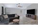 Comfortable living room features a large sectional sofa, stylish wood-look floors, and plenty of natural light at 4091 S Dew Drop Ct, Gilbert, AZ 85297