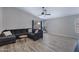 Bright living room with a large sectional sofa, a sliding glass door, and stylish wood-look floors at 4091 S Dew Drop Ct, Gilbert, AZ 85297
