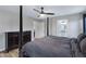 Spacious main bedroom with a four-poster bed, ceiling fan, and en-suite bathroom at 4091 S Dew Drop Ct, Gilbert, AZ 85297