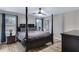Inviting main bedroom with a four-poster bed, neutral walls, and ample natural light from the windows at 4091 S Dew Drop Ct, Gilbert, AZ 85297