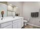 Well-lit bathroom with a white double sink vanity and a glass-enclosed shower at 41553 W Springtime Rd, Maricopa, AZ 85138