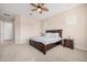 Spacious bedroom featuring a large bed, neutral walls, and a ceiling fan at 41553 W Springtime Rd, Maricopa, AZ 85138