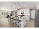 Bright kitchen features white cabinets, a large island with seating, and stainless steel appliances at 41553 W Springtime Rd, Maricopa, AZ 85138