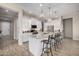 Beautiful kitchen featuring a central island, white cabinets, and modern lighting fixtures at 41553 W Springtime Rd, Maricopa, AZ 85138