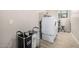 Functional laundry room with modern washer and dryer, shelving, and storage solutions at 41553 W Springtime Rd, Maricopa, AZ 85138