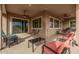 Spacious outdoor patio with seating, ceiling fans, and views of the backyard at 41553 W Springtime Rd, Maricopa, AZ 85138