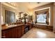 Expansive bathroom featuring double sinks, granite countertops, and a soaking tub under a window at 41607 N Club Pointe Dr, Phoenix, AZ 85086