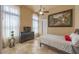 This bedroom boasts neutral walls, tiled flooring, and a ceiling fan for added comfort and appeal at 41607 N Club Pointe Dr, Phoenix, AZ 85086
