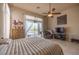Bedroom with neutral tones, ceiling fan, and a sliding door to the outside pool area at 41607 N Club Pointe Dr, Phoenix, AZ 85086