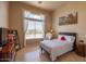 Bright bedroom featuring a large window offering scenic views, complemented by neutral walls and tiled flooring at 41607 N Club Pointe Dr, Phoenix, AZ 85086