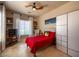 Welcoming bedroom featuring a full bed, TV, and a bright window with decorative sheer curtains at 41607 N Club Pointe Dr, Phoenix, AZ 85086