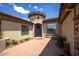 Elegant home entrance featuring a decorative iron door, brick-paved courtyard, and charming turret detail at 41607 N Club Pointe Dr, Phoenix, AZ 85086