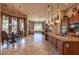 Open-concept living featuring a kitchen with granite countertops and travertine floors at 41607 N Club Pointe Dr, Phoenix, AZ 85086