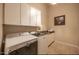 Well-lit laundry room featuring a Maytag washer/dryer, white cabinets, and a granite counter at 41607 N Club Pointe Dr, Phoenix, AZ 85086
