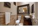 Stylish powder room with a vessel sink, elegant mirror, and decorative wall accents at 41607 N Club Pointe Dr, Phoenix, AZ 85086