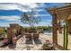 Beautiful backyard with a built in fireplace, pool, water feature, and covered patio area at 42211 N Long Cove Way, Anthem, AZ 85086