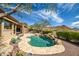 Beautiful backyard featuring a sparkling pool, scenic mountain views, and manicured landscaping at 42211 N Long Cove Way, Anthem, AZ 85086
