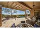 Covered patio with a swimming pool, mountain views, and comfortable seating at 42211 N Long Cove Way, Anthem, AZ 85086