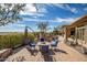 Inviting backyard patio with a fire pit, comfortable seating, and beautiful landscaping at 42211 N Long Cove Way, Anthem, AZ 85086