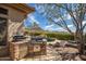 Stunning outdoor area with a grill, pool, lush landscaping, and mountain views at 42211 N Long Cove Way, Anthem, AZ 85086