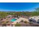 Secluded backyard retreat with a hot tub, outdoor dining area, and panoramic views of the surrounding desert landscape at 42211 N Long Cove Way, Anthem, AZ 85086