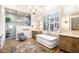 Bright bathroom with a large bathtub, walk-in shower, and dual vanities at 42211 N Long Cove Way, Anthem, AZ 85086