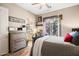 Charming bedroom features a vanity, ensuite bathroom and sliding glass doors at 42211 N Long Cove Way, Anthem, AZ 85086