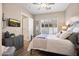 Comfortable bedroom with natural light, a decorative dresser, and a cozy bed at 42211 N Long Cove Way, Anthem, AZ 85086