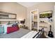 Comfortable bedroom featuring an entertainment center, TV, and walk-in closet at 42211 N Long Cove Way, Anthem, AZ 85086