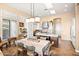 Bright dining area featuring a skylight, dining table, and seamless transition to a modern kitchen at 42211 N Long Cove Way, Anthem, AZ 85086