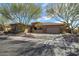 Stunning single-story home featuring a three-car garage, desert landscaping and mature trees at 42211 N Long Cove Way, Anthem, AZ 85086