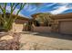 Desert home with a circular entry and beautiful desert landscaping at 42211 N Long Cove Way, Anthem, AZ 85086