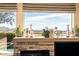 A stone fireplace with a decorated mantel offers scenic views of the mountains and pool at 42211 N Long Cove Way, Anthem, AZ 85086