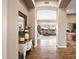 Inviting foyer with hardwood floors, decorative table and mirror, leading to the living room at 42211 N Long Cove Way, Anthem, AZ 85086