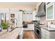 Well-appointed kitchen with modern appliances, custom cabinetry, stone countertops, and hardwood flooring at 42211 N Long Cove Way, Anthem, AZ 85086