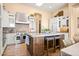 Gourmet kitchen with stainless steel appliances, custom cabinets, a mosaic backsplash, and a center island at 42211 N Long Cove Way, Anthem, AZ 85086