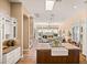 Open-concept kitchen and living room with an island sink, hardwood floors, and ample natural light at 42211 N Long Cove Way, Anthem, AZ 85086