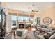 Bright living room featuring a stone fireplace, large windows with mountain views, and comfortable seating at 42211 N Long Cove Way, Anthem, AZ 85086