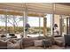 Living room view to a backyard pool featuring rock waterfall and desert landscaping at 42211 N Long Cove Way, Anthem, AZ 85086