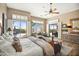 Main bedroom featuring plantation shutters, patio access, and a sitting area at 42211 N Long Cove Way, Anthem, AZ 85086