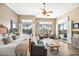 Bright main bedroom featuring plantation shutters, patio access, and a sitting area at 42211 N Long Cove Way, Anthem, AZ 85086