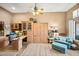 Well-lit home office featuring custom cabinets, a cozy seating area, and stylish furnishings at 42211 N Long Cove Way, Anthem, AZ 85086