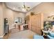 Elegant home office with custom wooden cabinetry, desk, and a comfortable armchair at 42211 N Long Cove Way, Anthem, AZ 85086