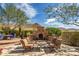 Charming backyard fireplace with seating, a beautiful view, and blue sky at 42211 N Long Cove Way, Anthem, AZ 85086
