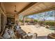 Expansive covered patio featuring comfortable seating, an outdoor kitchen, and a scenic mountain backdrop at 42211 N Long Cove Way, Anthem, AZ 85086