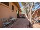 Charming outdoor patio area with a table, chairs, and beautiful desert landscaping at 42211 N Long Cove Way, Anthem, AZ 85086