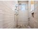 Modern shower featuring a rainfall showerhead, tiled walls, a built-in bench, and a convenient grab bar at 42211 N Long Cove Way, Anthem, AZ 85086