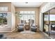 Bright sitting room with two chairs, white shutters, and access to the patio at 42211 N Long Cove Way, Anthem, AZ 85086